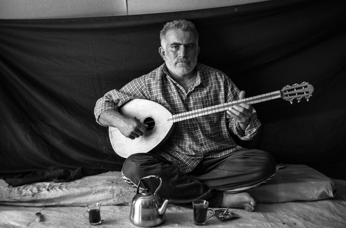 Omar, 37, holds a buzuq, or long-necked lute – the most important thing that he was able to bring with him to Domiz refugee camp in the Kurdistan Region of Iraq. Omar decided it was time to flee his home in the Syrian capital of Damascus the night that his neighbours were killed. “The killers came into their home, whoever they were, and savagely cut my neighbour and his two sons,” he recalls. Omar says that playing the buzuq “fills me with a sense of nostalgia and reminds me of my homeland. For a short time, it gives me some relief from my sorrows.